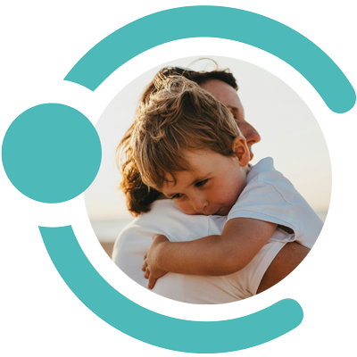 Mother and toddler hugging in sunlit outdoors